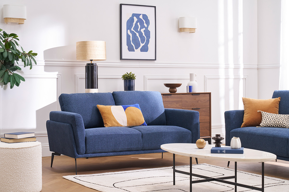 Canap� design 2 places en tissu bleu dans un salon lumineux avec table basse et d�coration moderne.